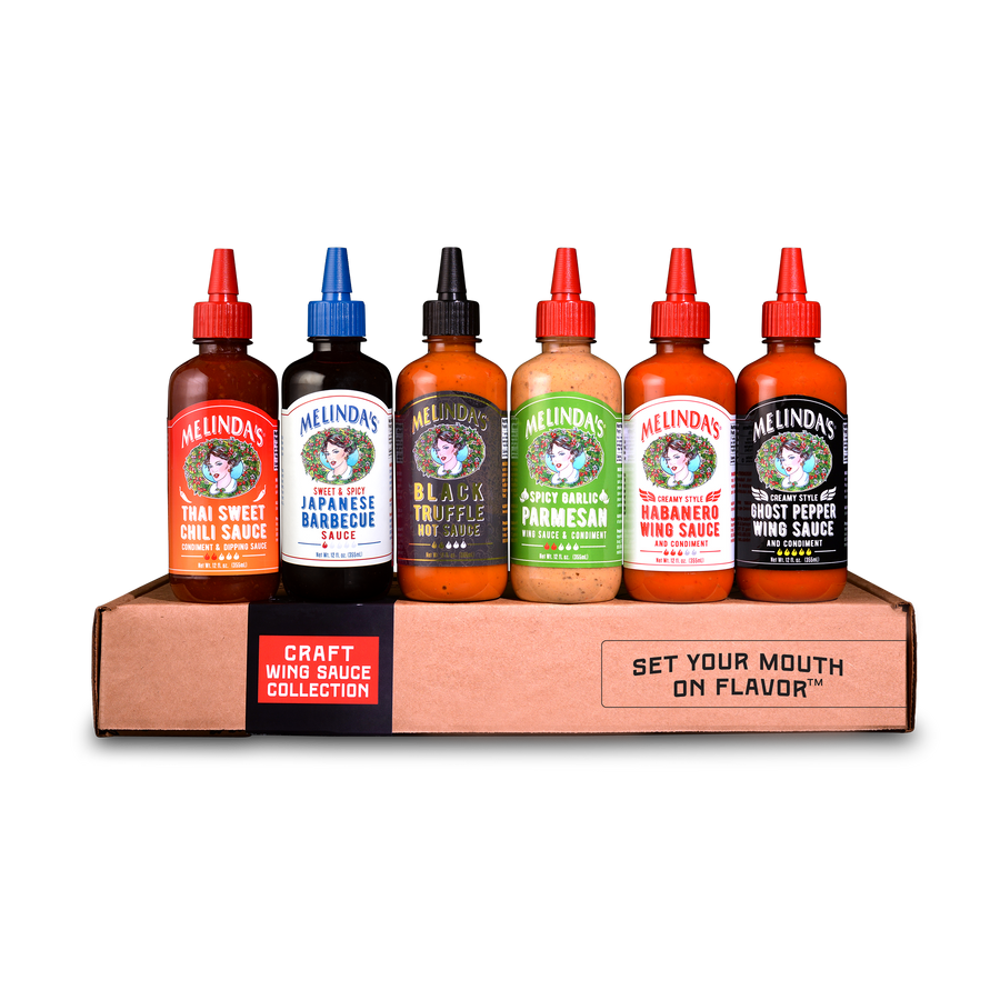 Six bottles of Melinda's hot sauce flavors displayed in a cardboard carrier box labeled "Craft Wing Sauce Collection"
