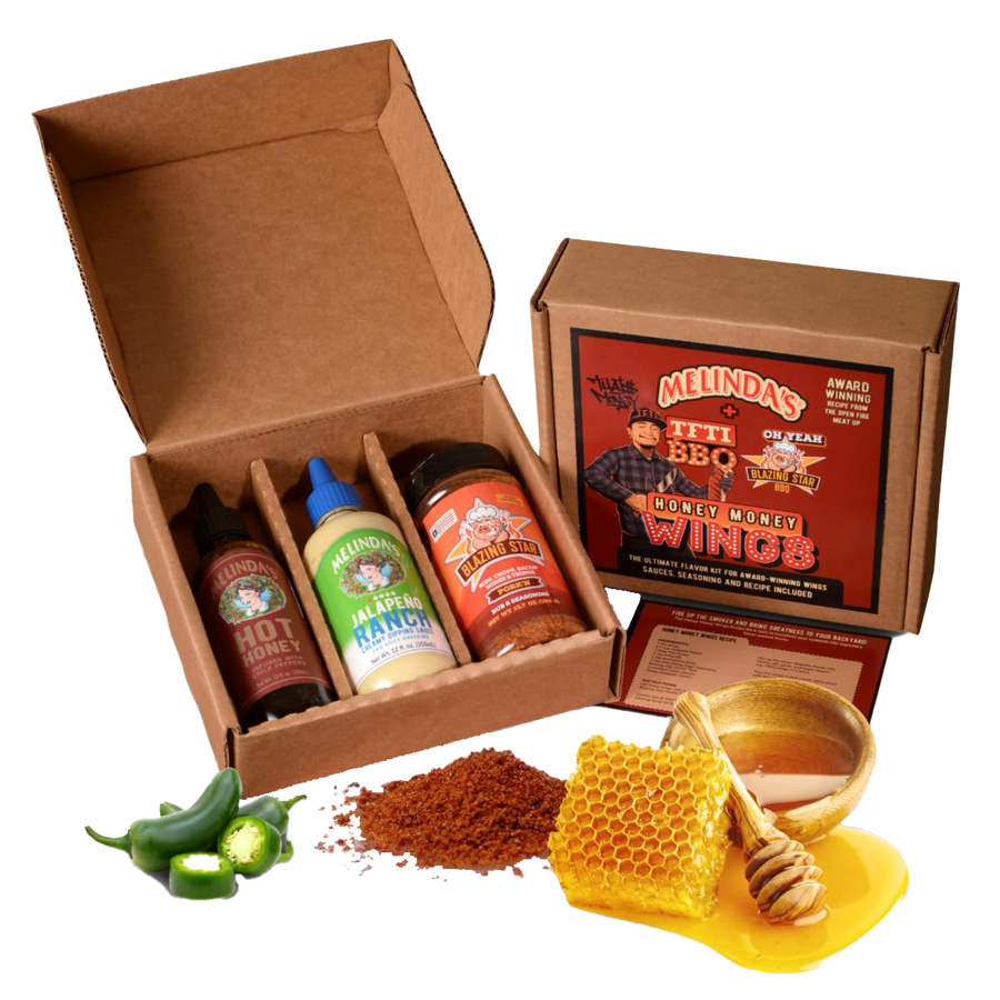 Melinda's BBQ gift set with sauces and seasonings in open cardboard box, alongside fresh jalapeños, spices, and honeycomb