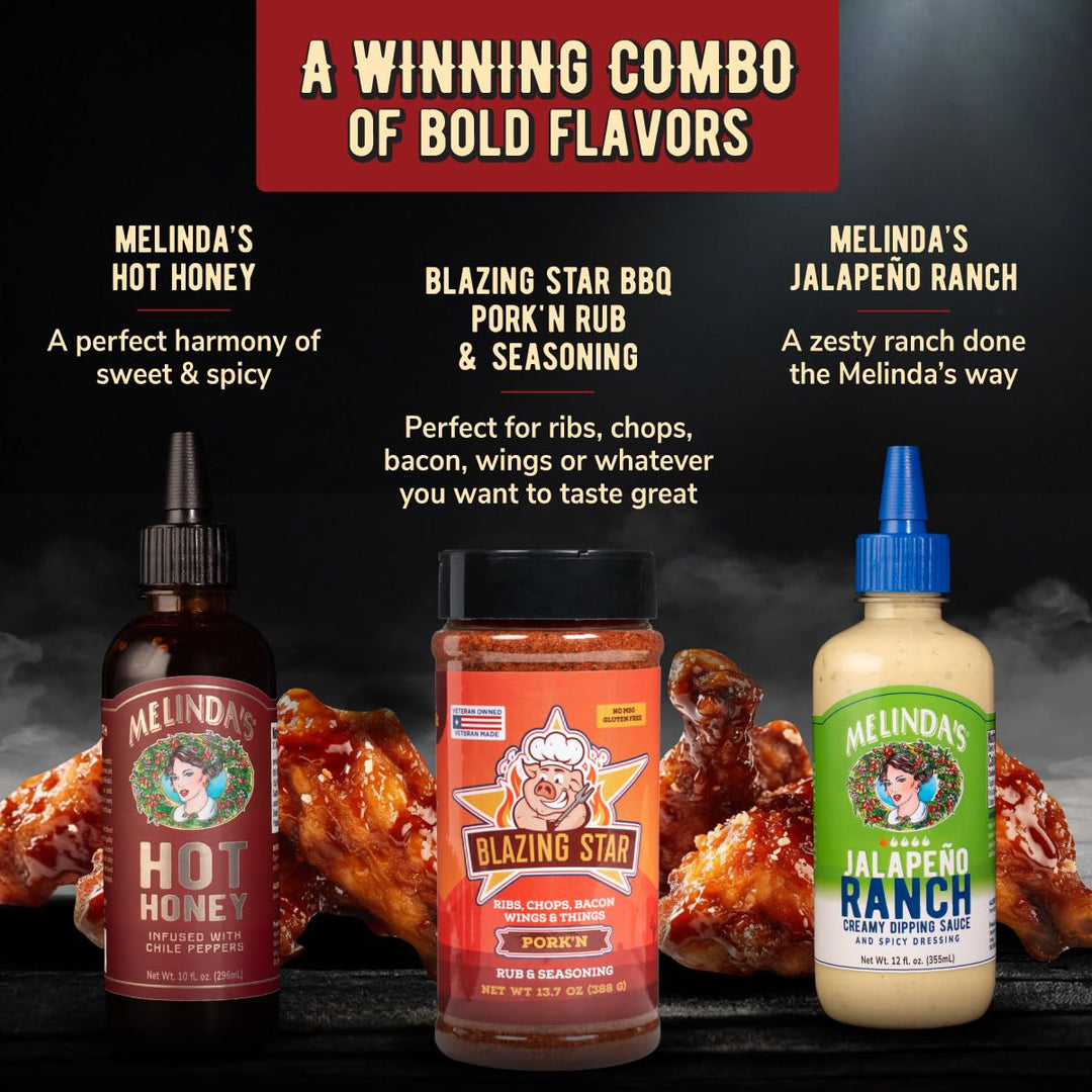 Three Melinda's sauce products on dark surface: Hot Honey bottle, Blazing Star BBQ seasoning jar, and Jalapeño Ranch...