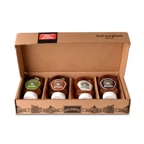 A box of Melinda's - Inspired by Fire Spicy Ketchup Collection bottles, featuring four different chile peppers.