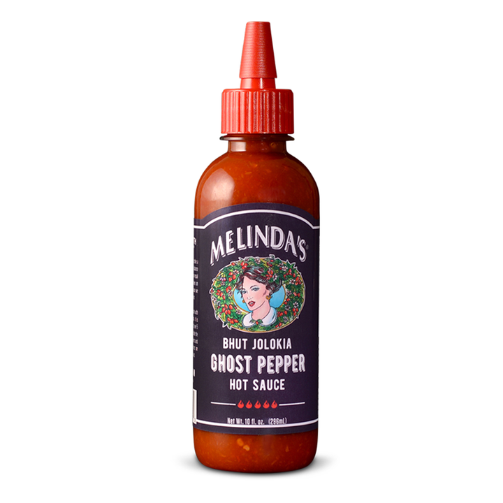 Bottle of Melinda's Bhut Jolokia Ghost Pepper Hot Sauce with brown glass bottle, red cap, and purple label featuring...