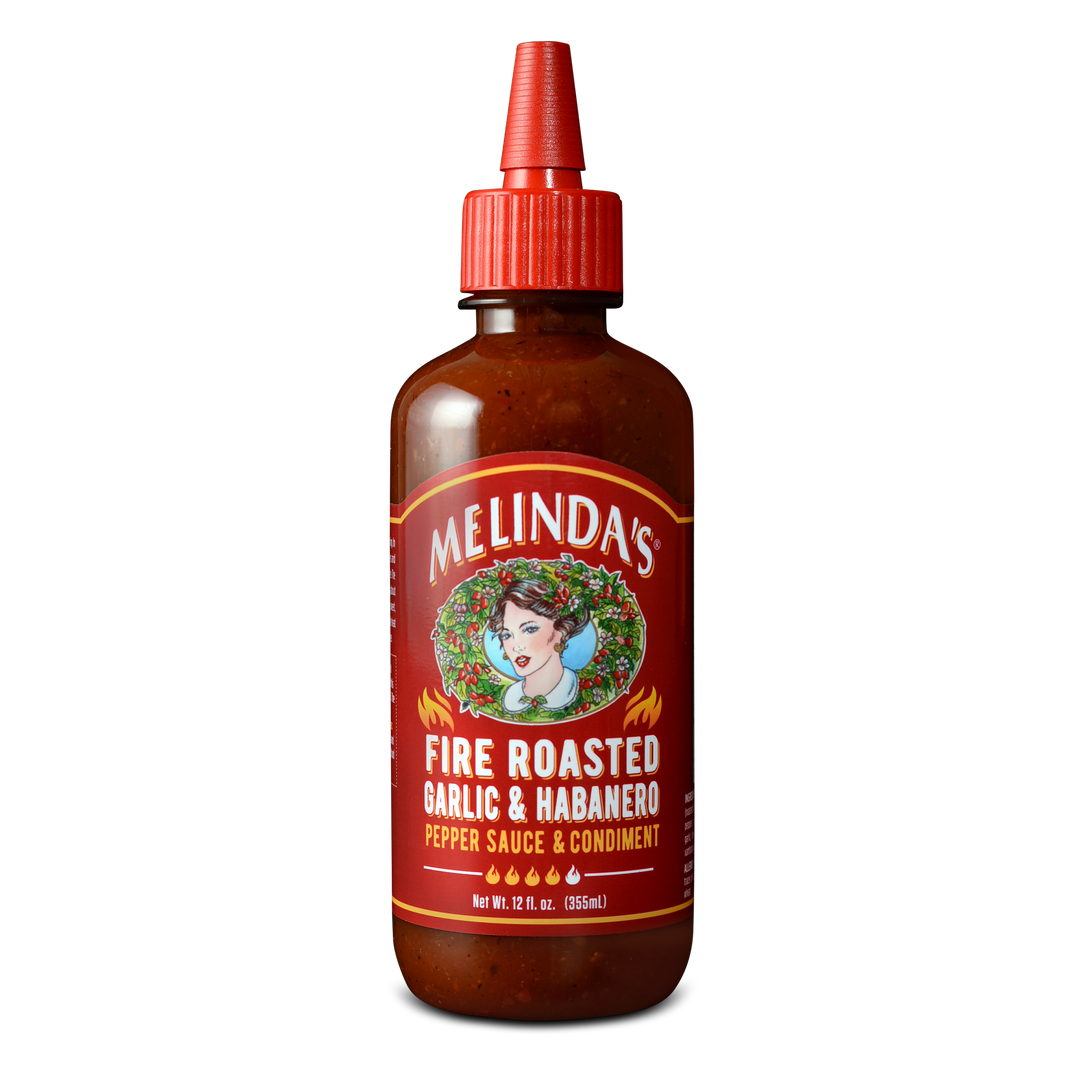 Melinda's Fire Roasted Garlic & Habanero pepper sauce bottle with red label and squeeze cap, 12 fl oz