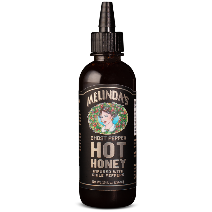 Dark amber glass bottle with dropper cap of Melinda's Ghost Pepper Hot Honey, featuring vintage-style label with woman's...
