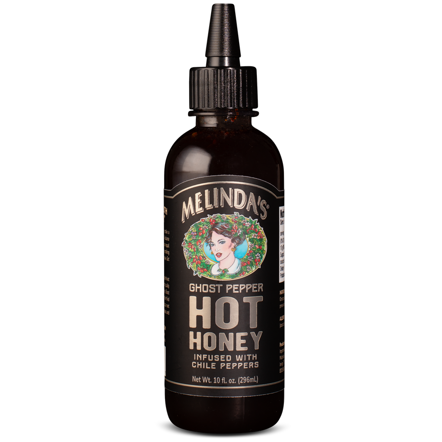 Dark amber glass bottle with dropper cap of Melinda's Ghost Pepper Hot Honey, featuring vintage-style label with woman's...