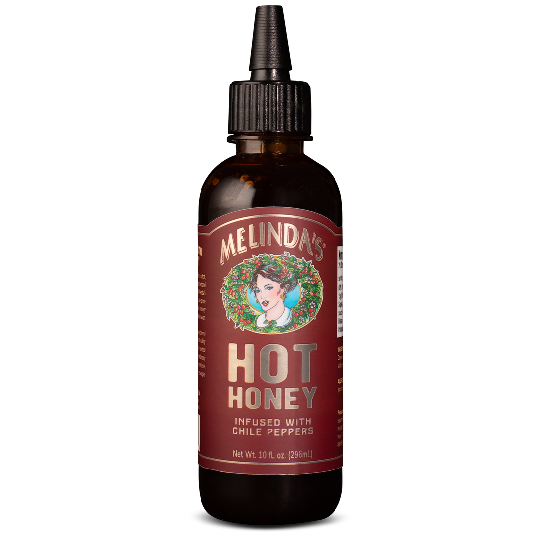 Melinda's Hot Honey sauce bottle with dropper cap, infused with chile peppers, 10 fl oz, amber glass bottle