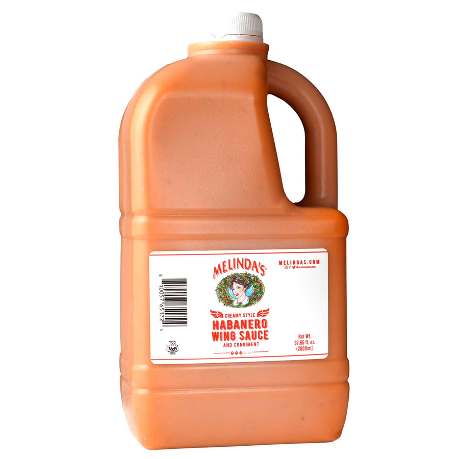 Large orange plastic jug of Melinda's Creamy Style Habanero Wing Sauce with white cap and handle, 67.85 fl oz size