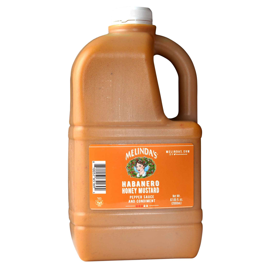 Large jug of Melinda's Habanero Honey Mustard pepper sauce and condiment with orange label and white cap, 67.65 fl oz