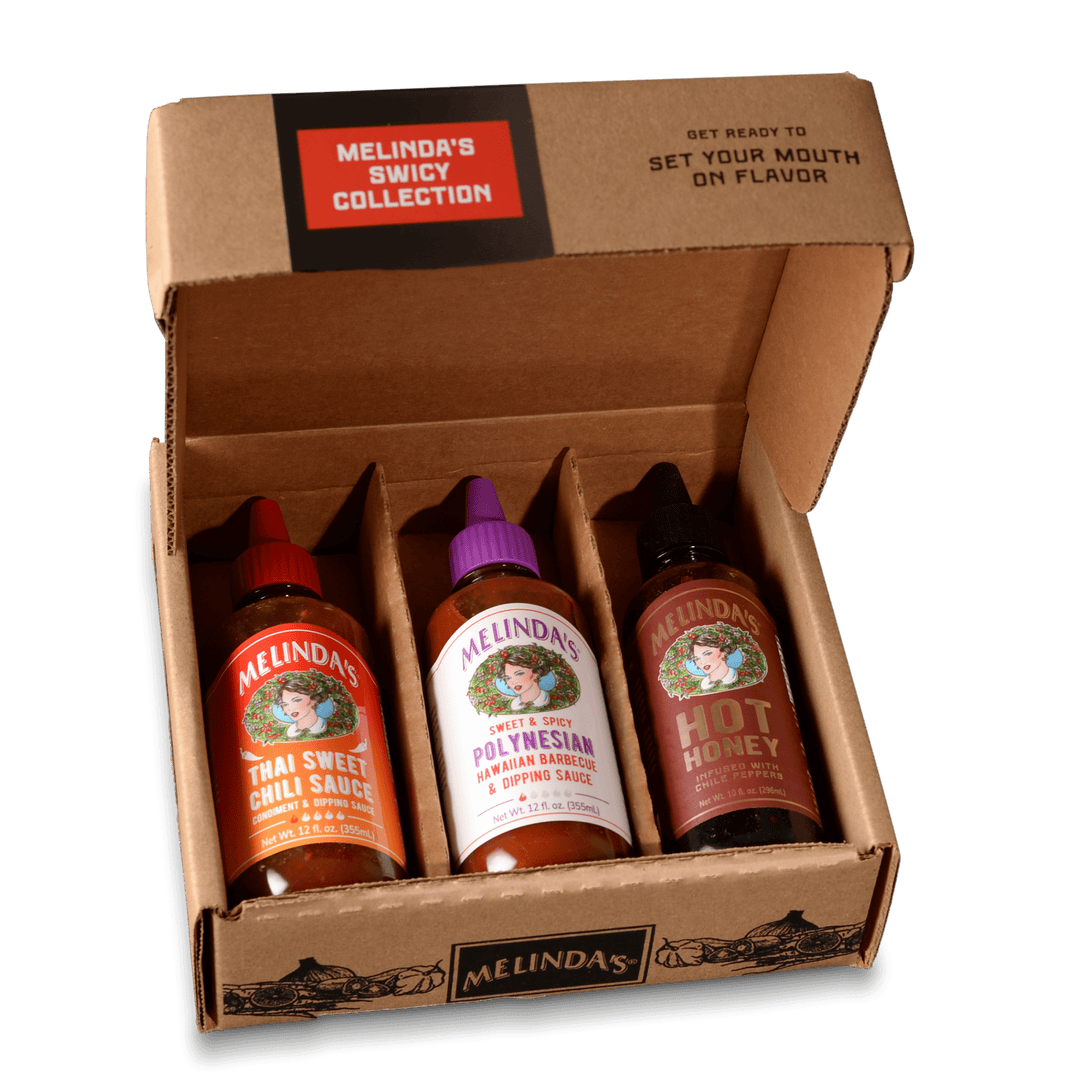 Three bottles of Melinda's hot sauce in brown cardboard gift box - Thai Sweet Chili, Polynesian Hawaiian BBQ, and Hot...
