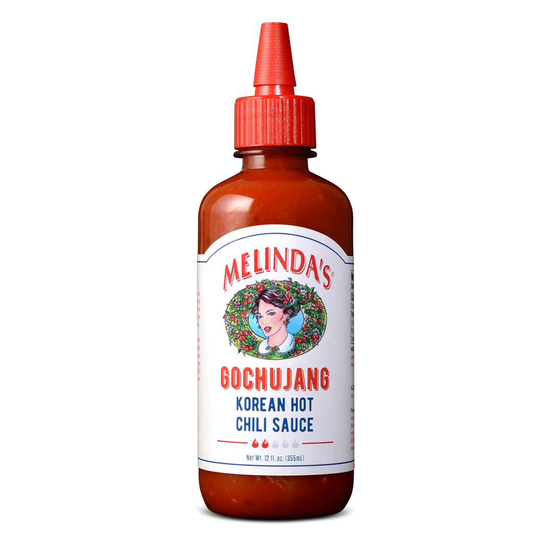 Melinda's Gochujang Korean Hot Chili Sauce bottle with red cap and white label featuring woman's portrait in wreath