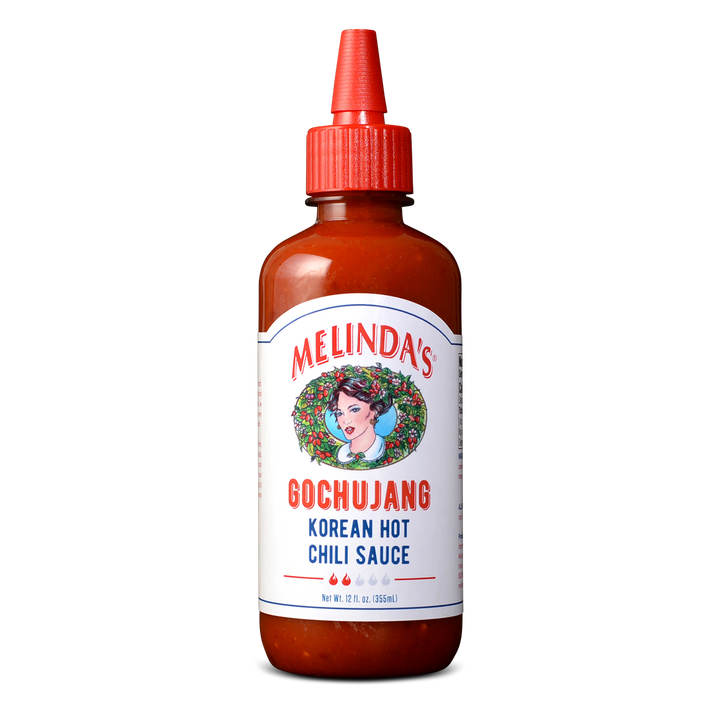 Melinda's Gochujang Korean Hot Chili Sauce bottle with red cap and white label featuring woman's portrait in wreath