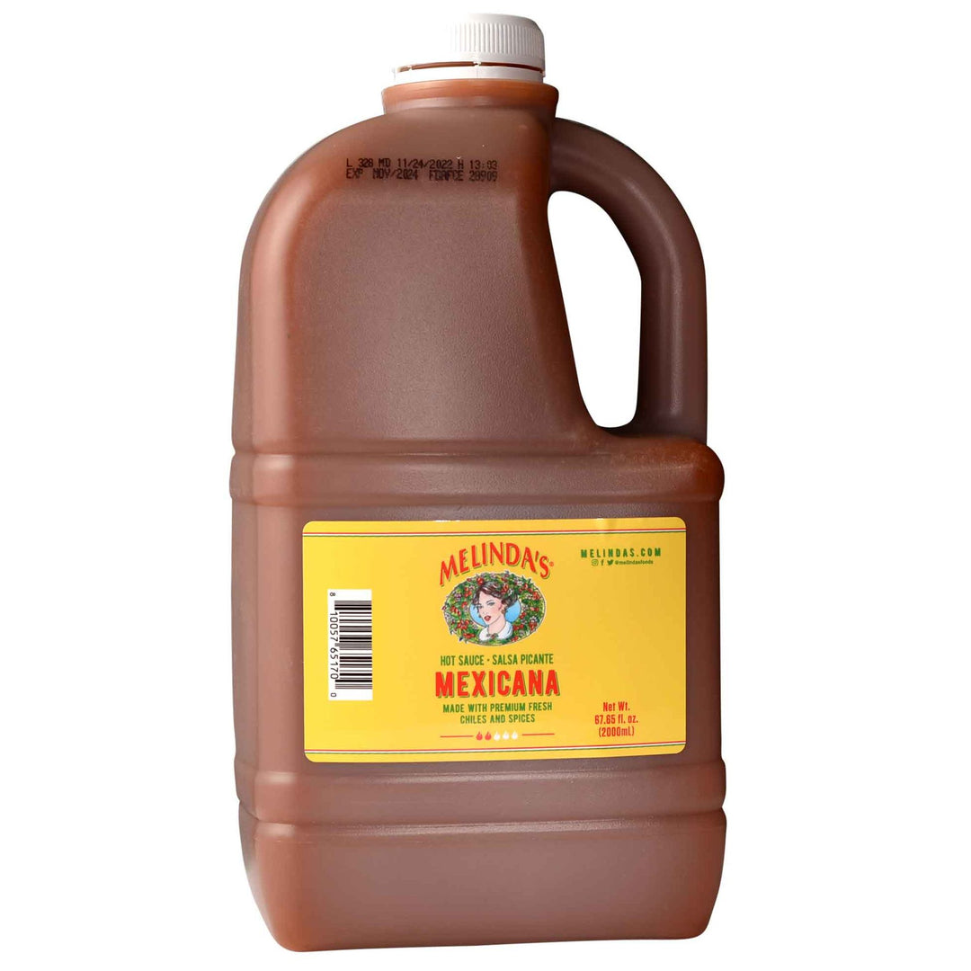 Large brown plastic jug of Melinda's Mexicana hot sauce with yellow label and white cap, 67.65 fl oz size