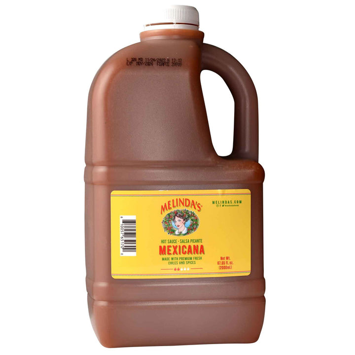 Large brown plastic jug of Melinda's Mexicana hot sauce with yellow label and white cap, 67.65 fl oz size