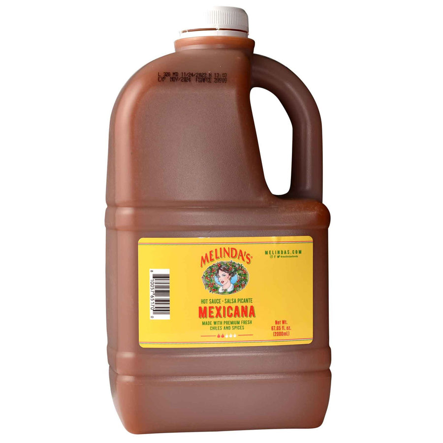 Large brown plastic jug of Melinda's Mexicana hot sauce with yellow label and white cap, 67.65 fl oz size