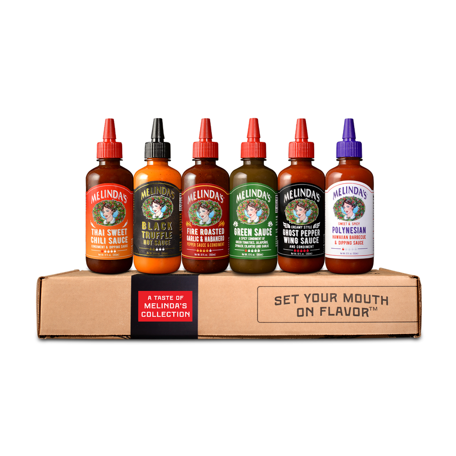 Six bottles of Melinda's hot sauce in different flavors displayed on a cardboard box with "Set Your Mouth on Flavor" text.
