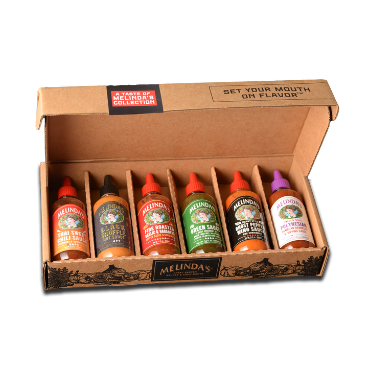 Cardboard box containing six bottles of Melinda's hot sauce varieties with "A Taste of Melinda's Collection" label