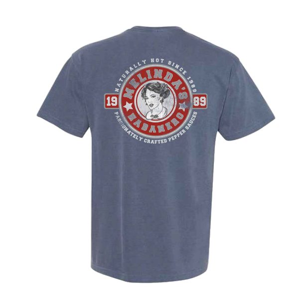Comfort Colors Pocket Tee – Washed Denim: A blue t-shirt with a graphic design featuring a logo of a woman on the back.
