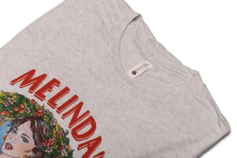 Light gray t-shirt with "MELINDA'S" text in red letters and colorful illustration of woman with flowers in her hair